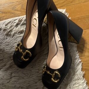 Gucci black heels with Gold accent